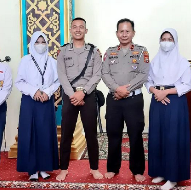 Photo 5: Students playing soccer on a green field under a bright blue sky, energetic and joyful
