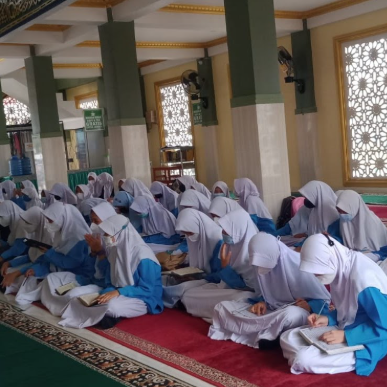 Photo 9: Students collaborating on a group project with laptops and notes in a bright study room